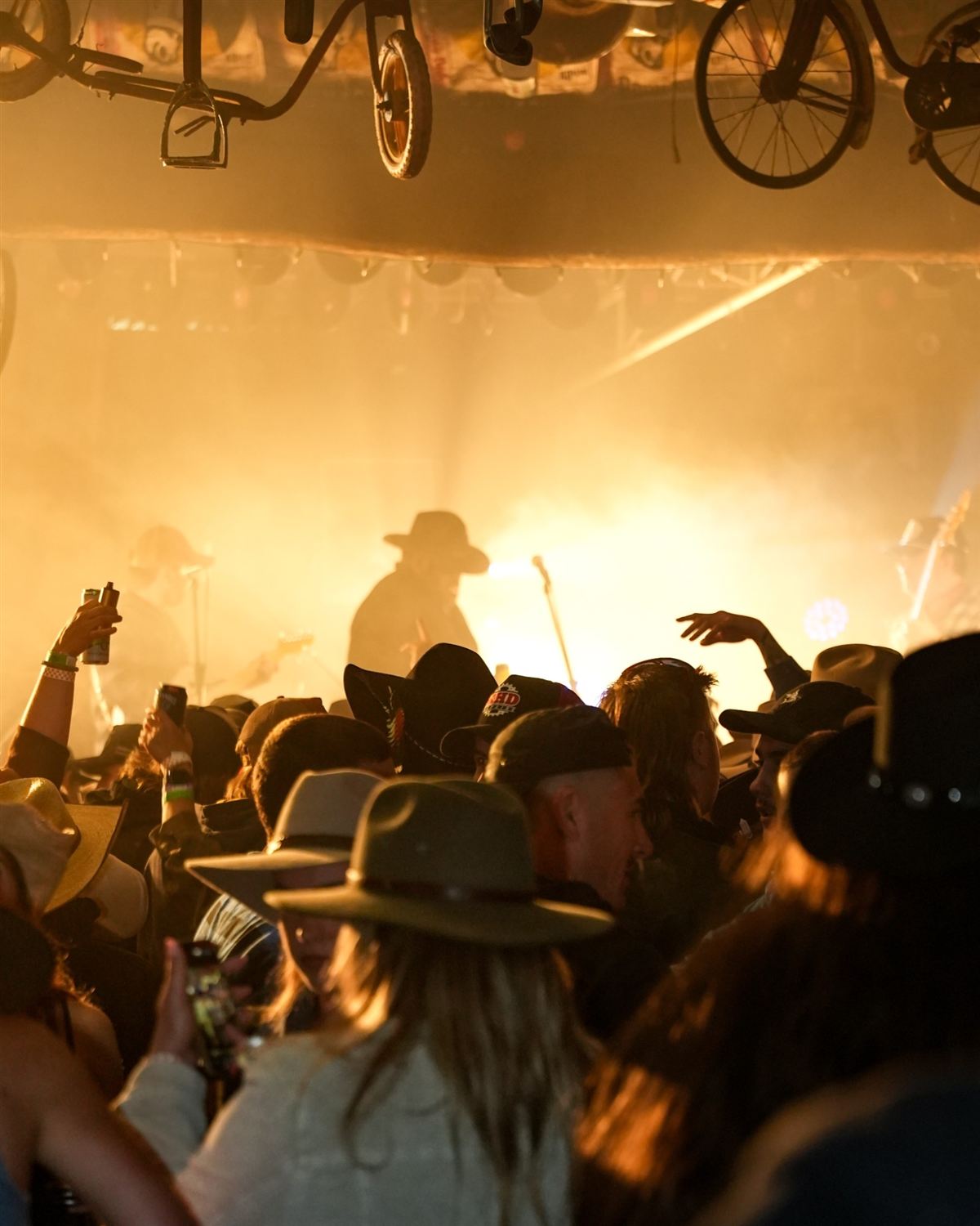 A packed crowd in cowboy hats at a Bradley Hall Band show
