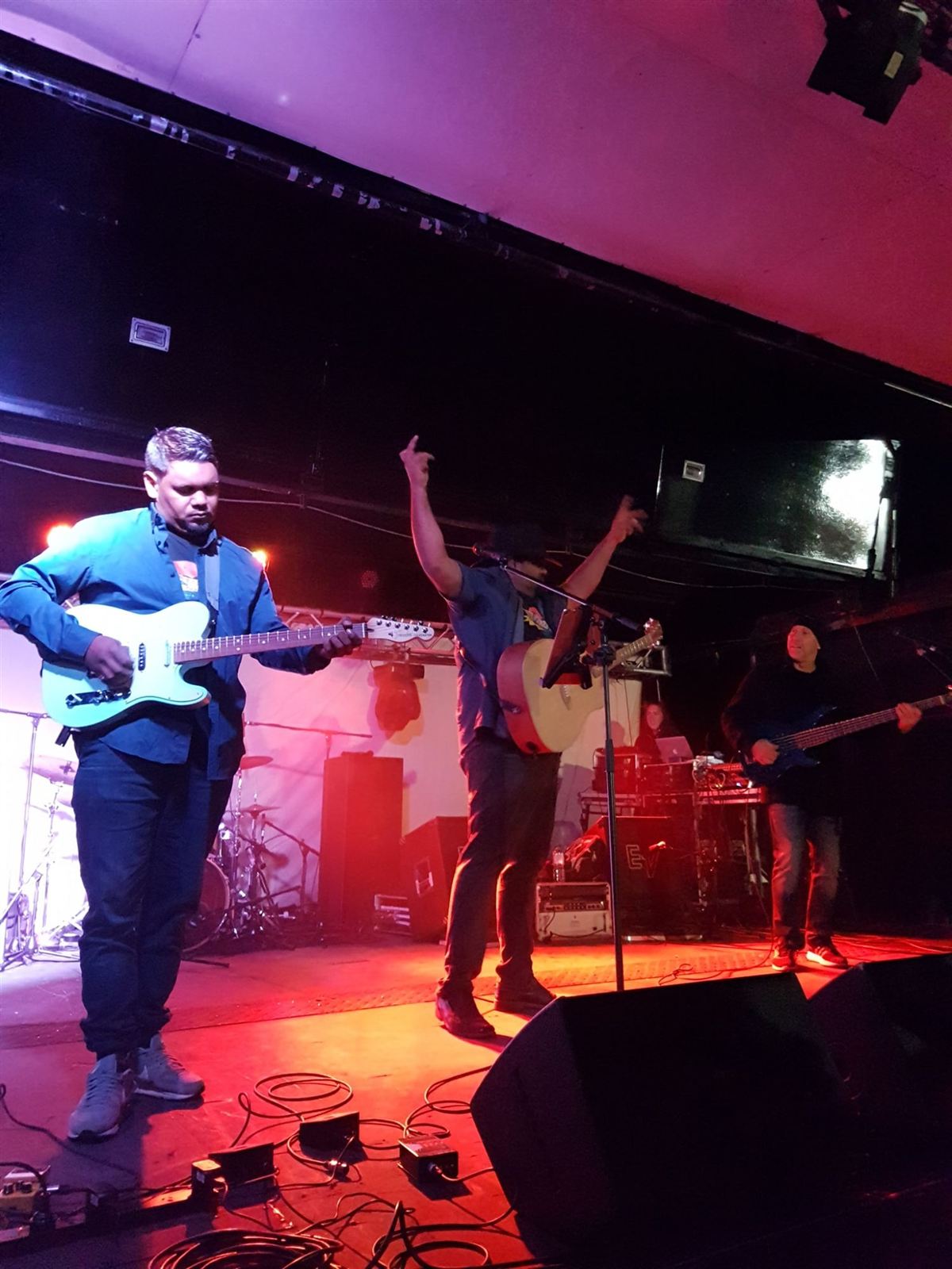 Bradley and his band on stage under red lights
